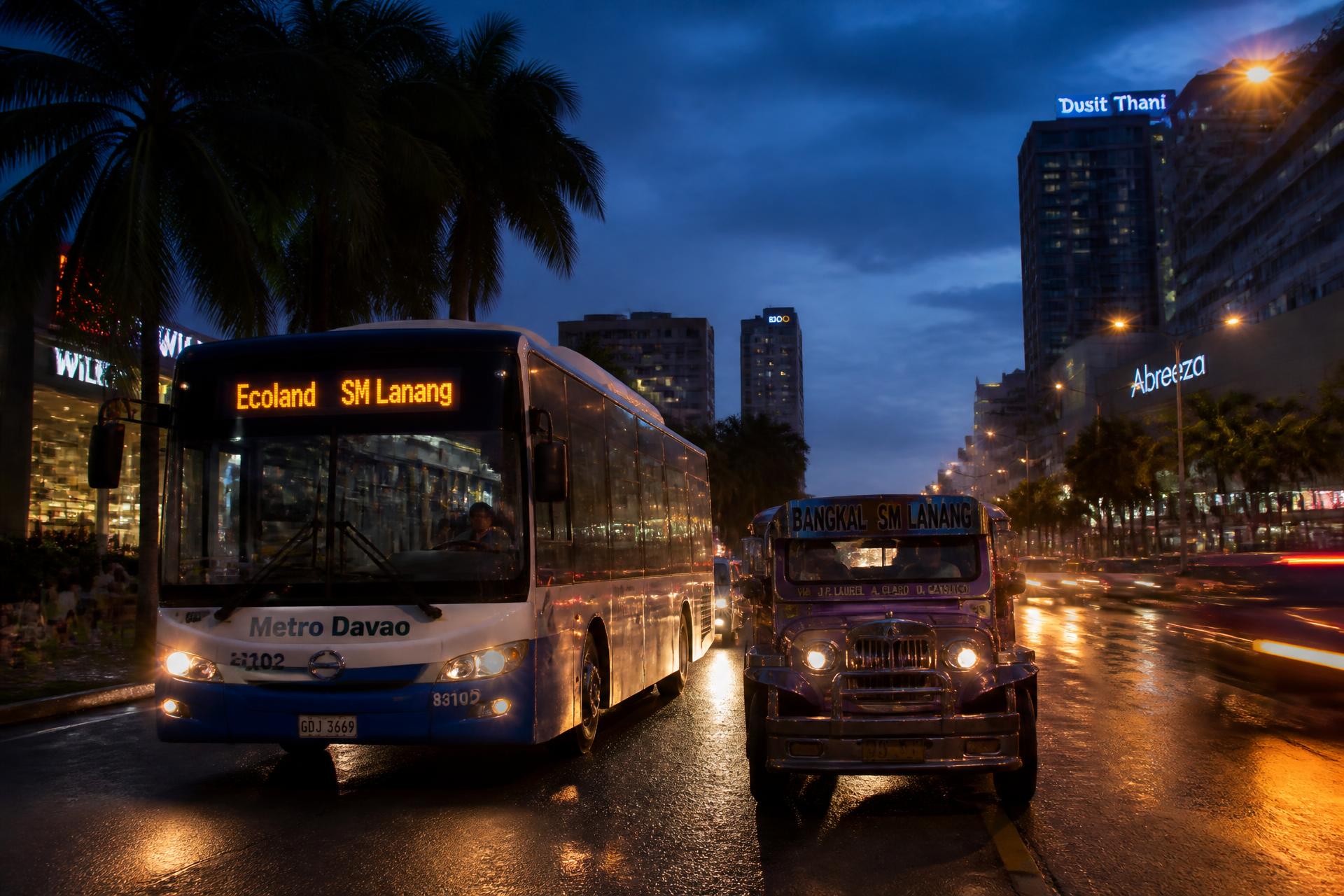 City traffic with buses and jeepneys on a Philippine avenue at dusk